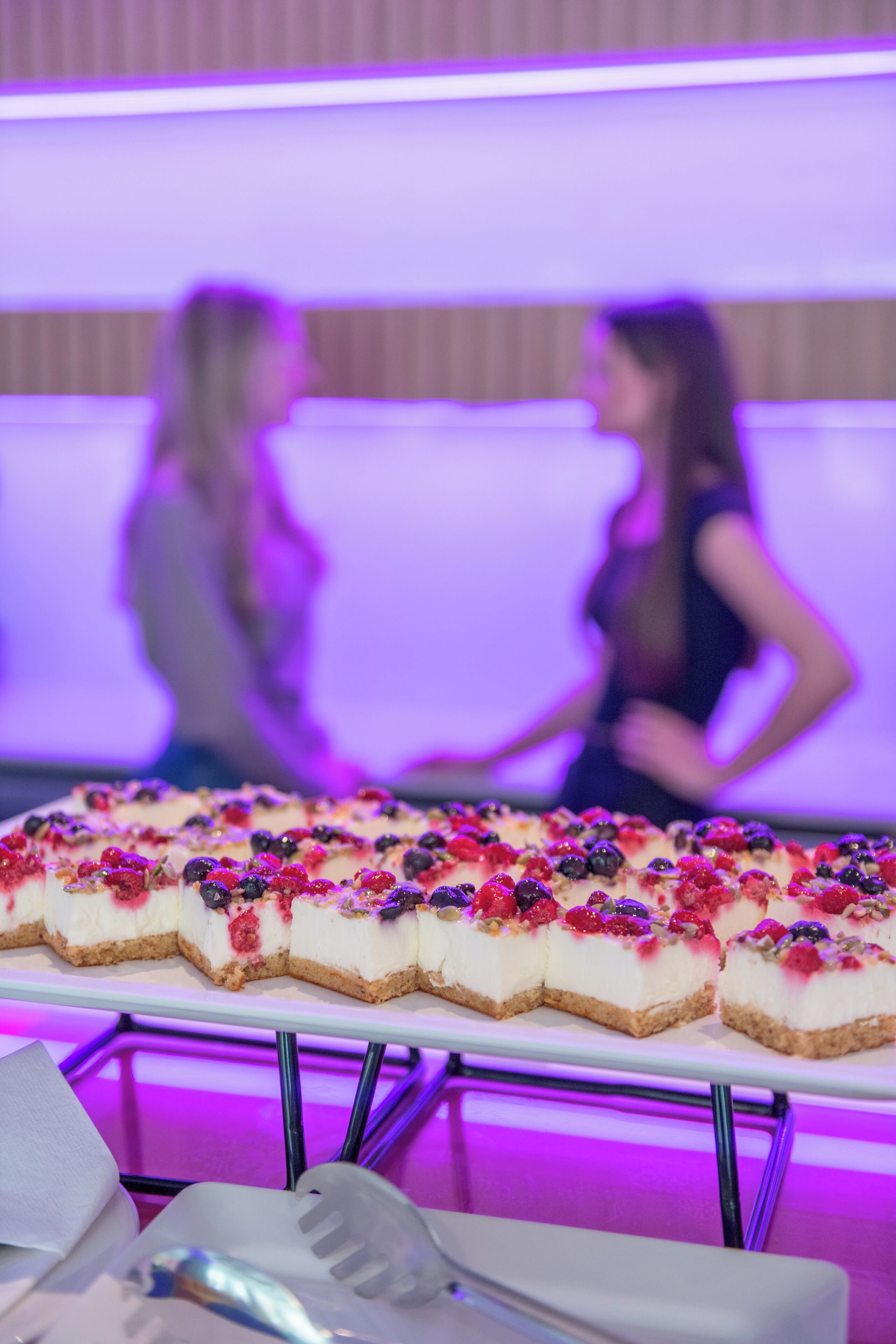 A dessert display with a white tray, a spoon, and a napkin.