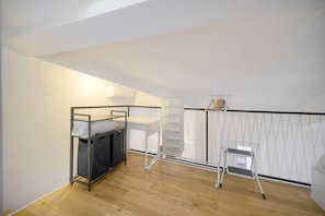 A small, well-lit room with a bunk bed, a desk, and a chair. - Question 24. August, 2-room apartment in the center of Antibes, quiet location` (Antibes)
