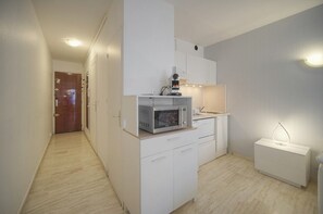 A compact kitchen with a microwave, a coffee machine, and a small sink. - One-bedroom apartment in France, Cannes (Cannes)