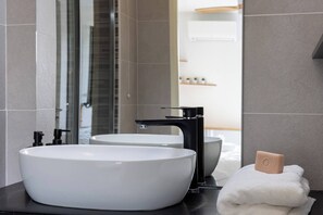 A modern bathroom with a large white sink, black faucet, and a mirror. - BEL AZUR (Antibes)