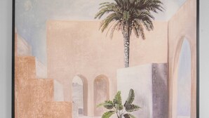 A framed painting of a serene courtyard with a palm tree, potted plants, and a water feature. - LE CLEMENCEAU (Cannes)