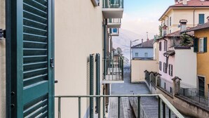 A narrow street with buildings on either side, balconies, and a clear sky. - Cozy Holiday Home by Interhome (Dongo)