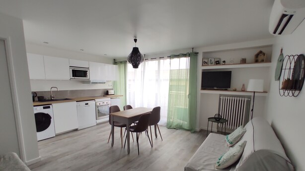 A modern apartment with a dining area, kitchenette, and living space. - Air-conditioned apartment with balcony, wifi, near ramparts (Avignon)