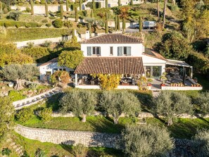 A modern two-story house with a tiled roof, surrounded by olive trees and a stone wall. - Beatrice, villa with pool and view over St Paul de Vence village (Saint Paul de Vence)