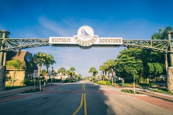 Stroll through a charming downtown adorned with vibrant greenery and welcoming, sunny skies.