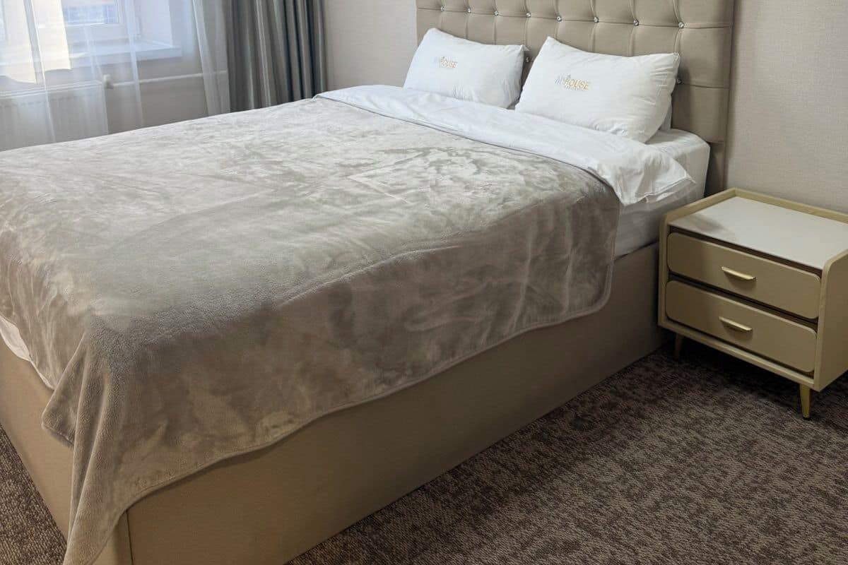 Desk, iron/ironing board, bed sheets