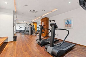 A gym with treadmills, elliptical machines, and weight equipment. - The Park 306 | Ocean View • Heated Pool • (Puerto Vallarta)