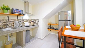 A compact kitchen with a microwave, toaster, and stainless steel refrigerator. - Condo Pool Palapa Lounge Free Parking Onsite (La Paz)