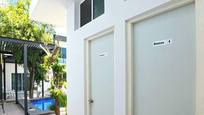 A building with two doors labeled 'Damas' and 'Calafell.' - Shared Pool Oasis  Near Malecon  BBQ  Wi-Fi (La Paz)