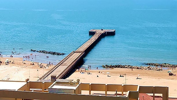 A pier extending into the sea with a beach in the foreground. - Apartment with TERRACE ON THE SEAwith breathtaking views. 50 meters from the beach (Gela)