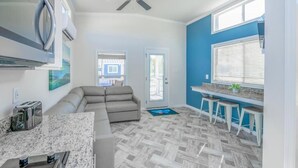 A modern kitchen with a granite countertop, a built-in oven, and a ceiling fan. - Luray RV Resort on Shenandoah River (Luray)