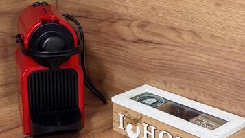 A red espresso machine next to a wooden box with 'I ♥ HOME' written on it.