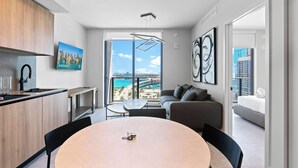 A modern apartment with a kitchen, dining area, and living space with a city view. - Sleek 1BR | Bay Views | Walk to Kaseya Center (Miami)