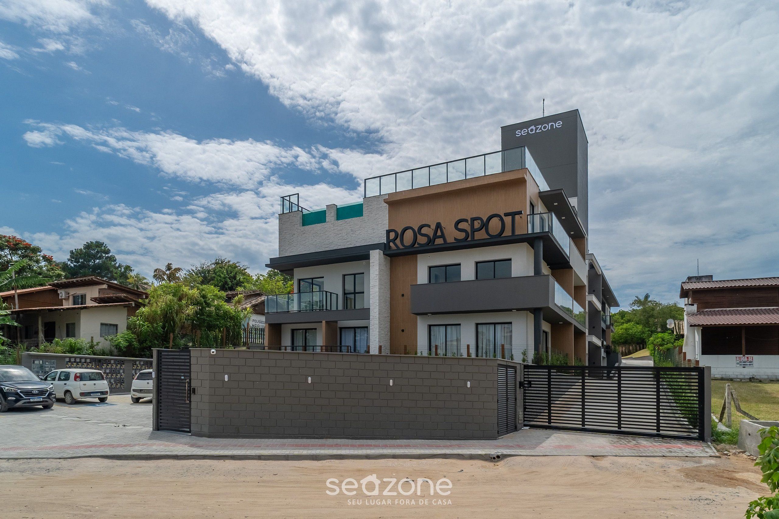 A multi-story building with a sign reading 'ROSA SPOT' and 'seazone' on the facade.