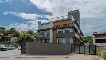 A multi-story building with a sign reading 'ROSA SPOT' and 'seazone' on the facade.