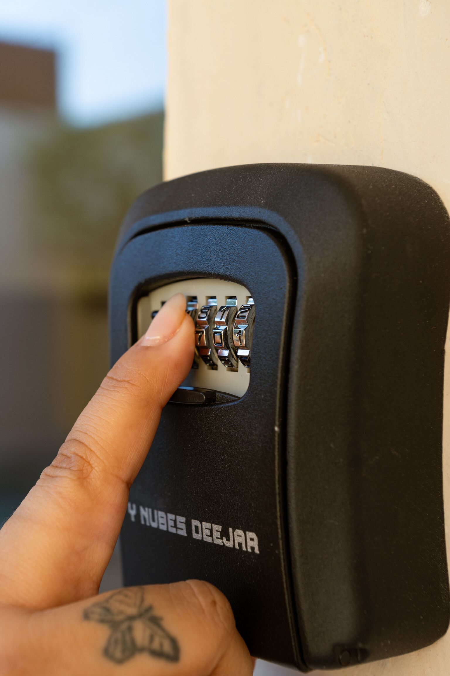 A hand inserting a key into a lock.