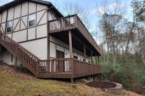 A two-story building with a balcony and a staircase.