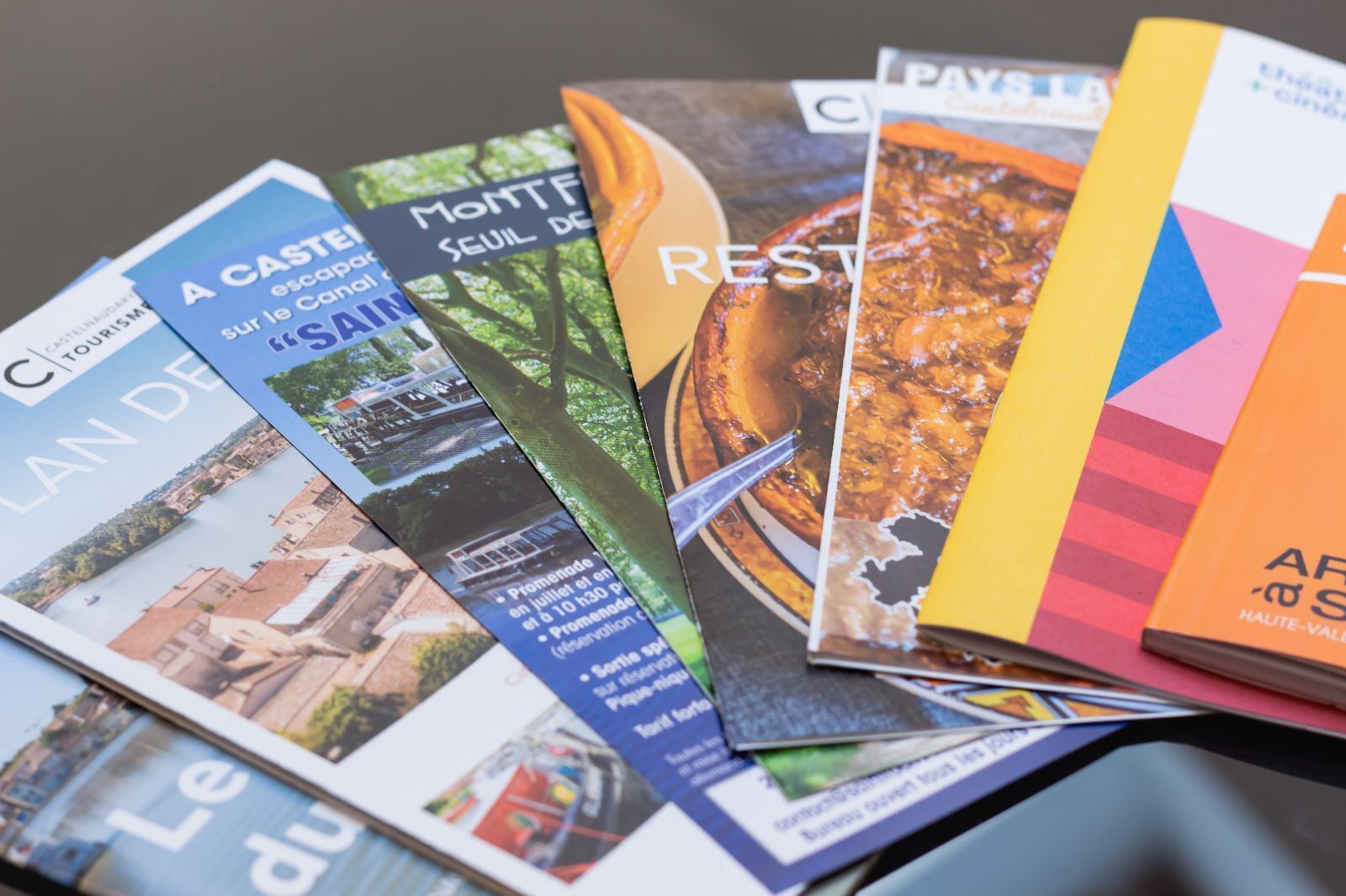 Brochures with various travel destinations and activities.