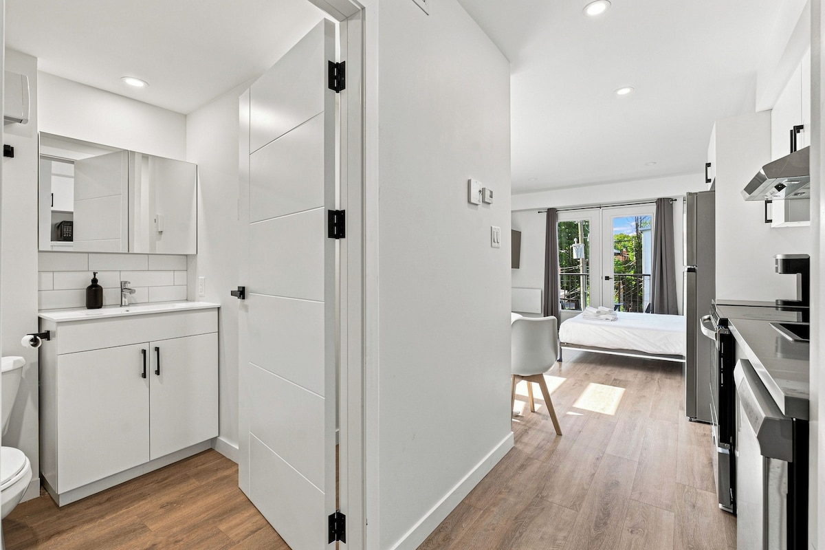 A modern kitchen with a built-in oven and a dining area with a table and chairs.