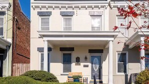 A two-story townhouse with a front porch, a mailbox, and a number plaque. - Stylish Scott’s Addition Stay w/ Fire Pit & Yard (Richmond)