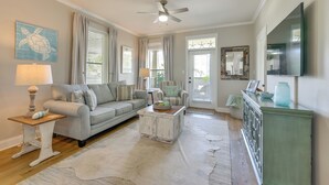 A living room with a sofa, coffee table, and a television. - < 1 Mi to Beach: 30A Escape w/ Bikes + Pool Access (Santa Rosa Beach)