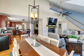 A spacious living area with a dining table, chairs, a fireplace, and a staircase. - Community Pool Access! Sleepy Hollow Lake Hideaway (Athens)