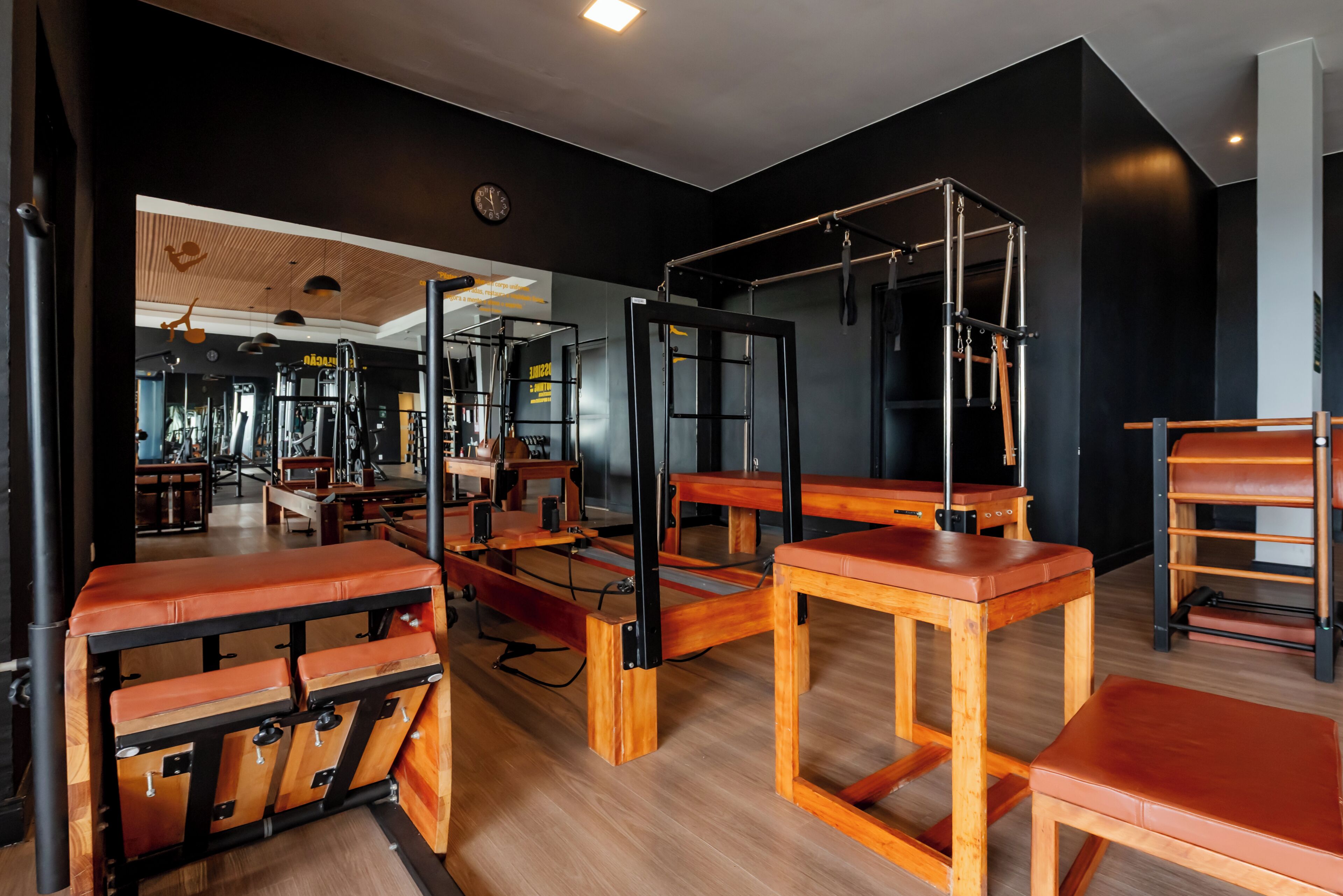 A gym with wooden benches and exercise equipment.