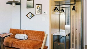 A modern room with a sofa, a small table, a mirror, and a cabinet. - Park City Peaks (Park City)