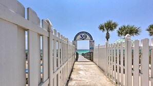 A pathway leading to a beach entrance with a sign reading "39" and palm trees on the right. - Walk to Shore: Townhome w/ Pool Access in PCB! (Panama City Beach)