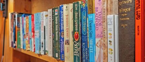 A bookshelf with a variety of books, including titles like 'The Secret' and 'The Bridge.'