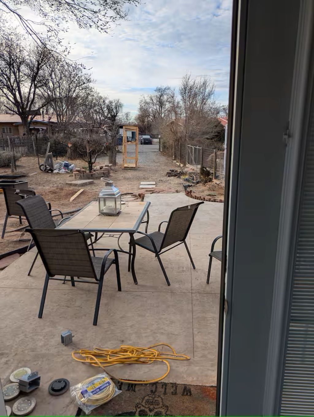 A patio with outdoor furniture, a table, and chairs.