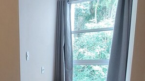 A room with a bed, a desk, and a window with curtains. - Quiet apartment, excellent location in Copacabana, 5 minutes from the beach. (Rio de Janeiro)