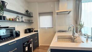 A modern kitchen with a microwave, coffee maker, and a sink. - Akikawa Koshi 7 | 15 min to TSMC | Entire 4LDK House | Up to 7 Guests (合志市)