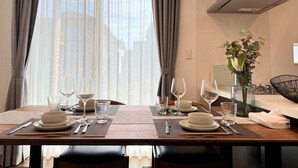 A dining table set for two with plates, glasses, and cutlery. - Akikawa Koshi 5 | 15 min to TSMC | Entire 3LDK House | Up to 4 Guests (合志市)