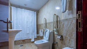 A bathroom with a toilet, bidet, and sink. - Gulf Star Hotel (Dubai)