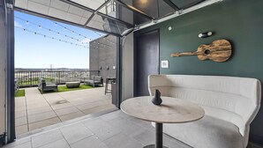 An open-plan space with a seating area, a table, and a view of the outside.