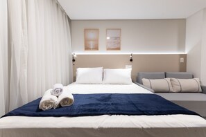 A hotel room with a bed, a sofa, and two framed pictures on the wall. - Vivant New Building Seafront in Recife (Recife)