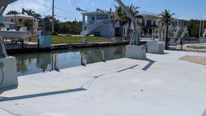 A marina with boats, a dock, and a building with a balcony. - The Friendly Pelican
2-BDR 2-BATH on a canal w/AC in Big Pine Key (Big Pine Key)