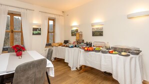 A dining area with a buffet setup, including various food items and condiments. - Penzion Quest Loket (Loket)