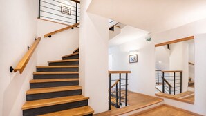 A staircase with wooden steps and metal railings, leading to an upper floor. - Penzion Quest Loket (Loket)