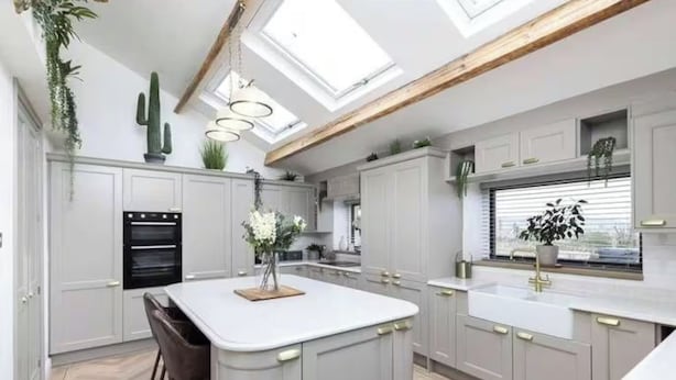 A modern kitchen with a central island, built-in oven, and pendant lighting. - Farm House - Sleeps 16 - Hot Tub - Pet Friendly (Skipton)