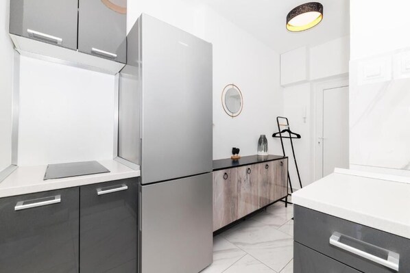 A modern kitchen with a refrigerator, cabinets, and a countertop. - Apartment Nevera by Belmont Realty (Zadar)