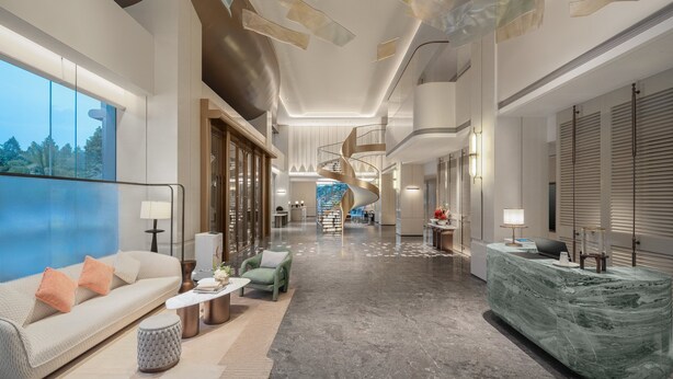A spacious hotel lobby with a central spiral staircase, a reception desk, and a seating area with a sofa and coffee table. - Holiday Inn Quanzhou Jinjiang Airport by IHG (Quanzhou)