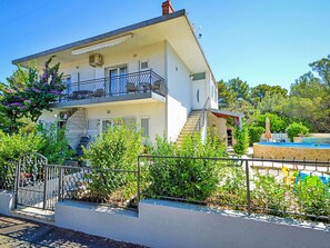 A two-story building with a balcony, a swimming pool, and a garden. - Antonia by Interhome (Brodarica)