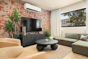 TV, books - Modern 3BR Condo w/ Terrace | Walk to Beach (San Juan)