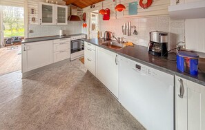 A modern kitchen with white cabinets, a Bosch dishwasher, and a coffee maker. - Nice home in Broager with WiFi (Broager)