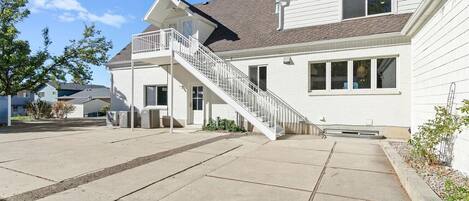 A two-story house with a front porch, a staircase leading to the second floor, and a garage.
