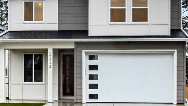 A two-story house with a garage, a front door, and a number '2343' on the door. - Quiet Private Room Victoria - PS5, Fast WiFi, Parking (Langford)