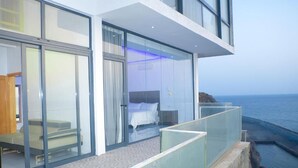 A modern hotel room with a glass balcony overlooking the sea. - The View Hotel CV (Sao Filipe)