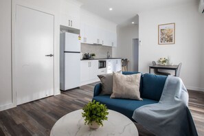 Living area - Walk to Mall & Train | Private Suite Kitchen & A/C (Oxley)